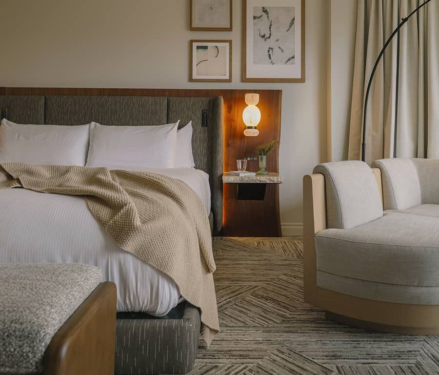Classic guest room at Rimrock Banff, Emblems Collection with soft lighting, refined furnishings, and a cozy mountain retreat feel.