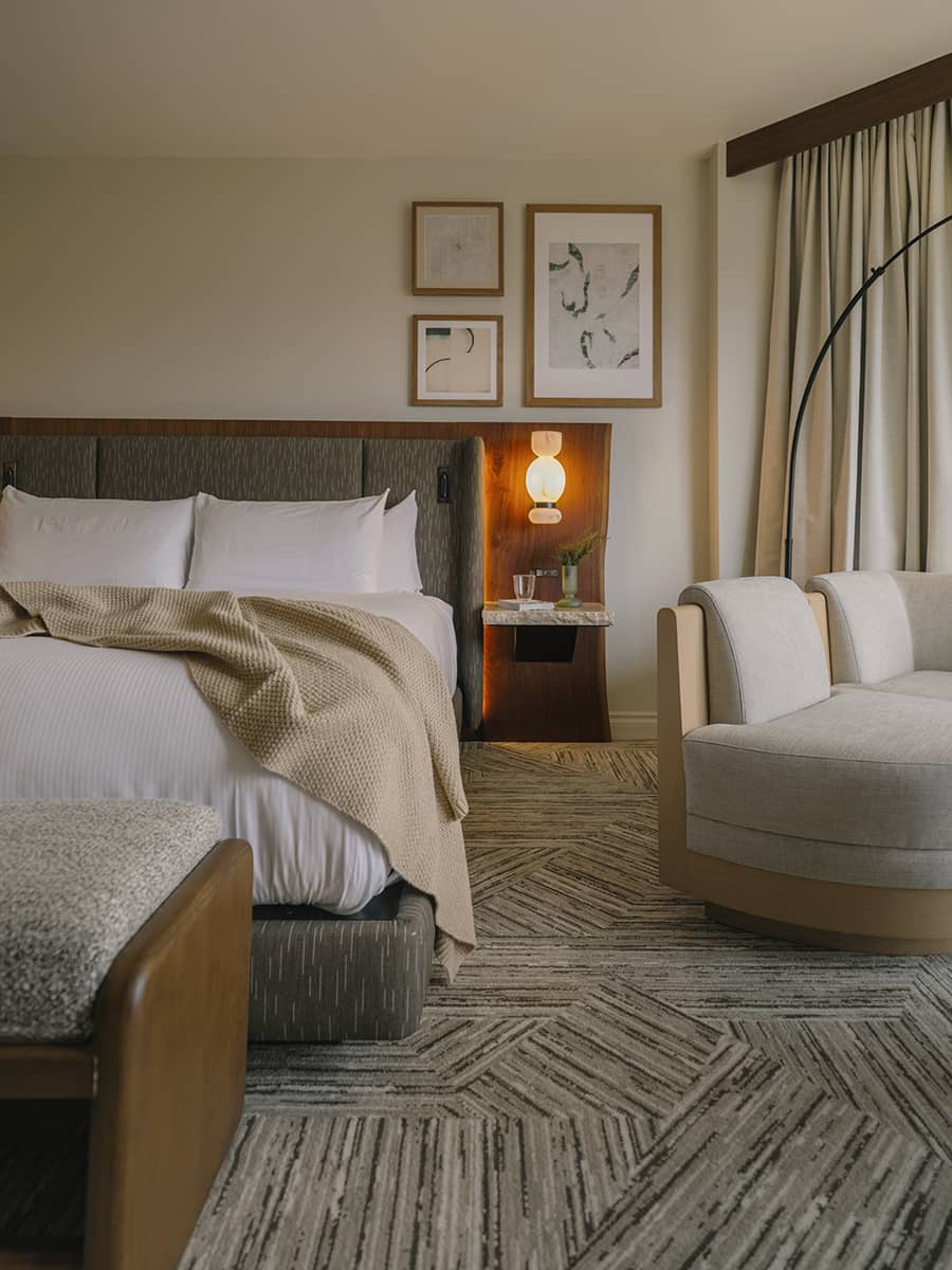 Classic guest room at Rimrock Banff, Emblems Collection with soft lighting, refined furnishings, and a cozy mountain retreat feel.