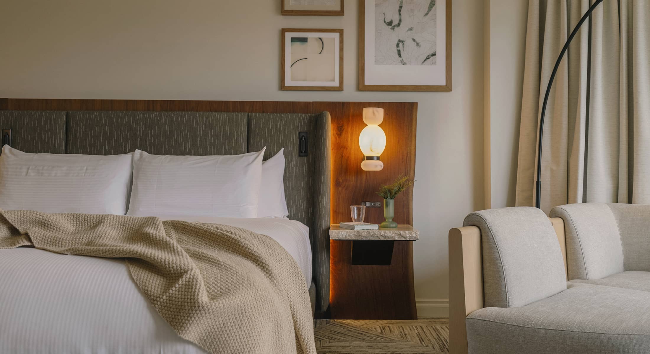 A tranquil Luxury peak view room at Rimrock Banff featuring soft lighting, natural wood accents, and an inviting atmosphere inspired by the mountains.