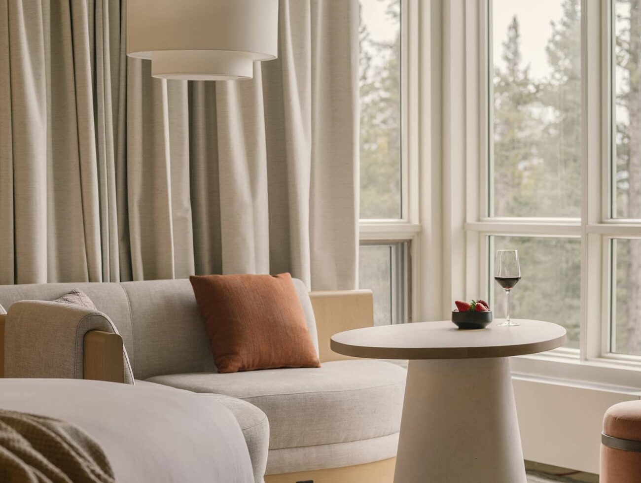 A tranquil Premium Room at Rimrock Banff featuring soft lighting, natural wood accents, and an inviting atmosphere inspired by the mountains.