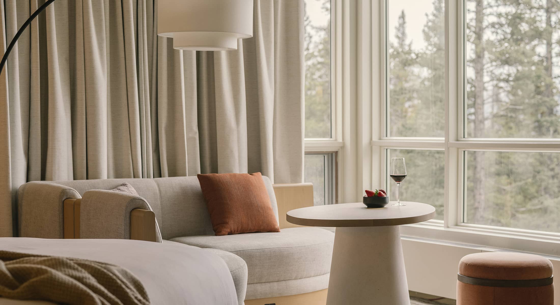 A tranquil Premium Room at Rimrock Banff featuring soft lighting, natural wood accents, and an inviting atmosphere inspired by the mountains.