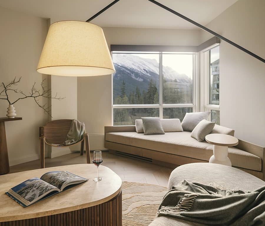 A serene Rimrock Banff guest room with a plush bed, warm lighting, and natural tones that create an inviting sense of calm and refined mountain comfort.