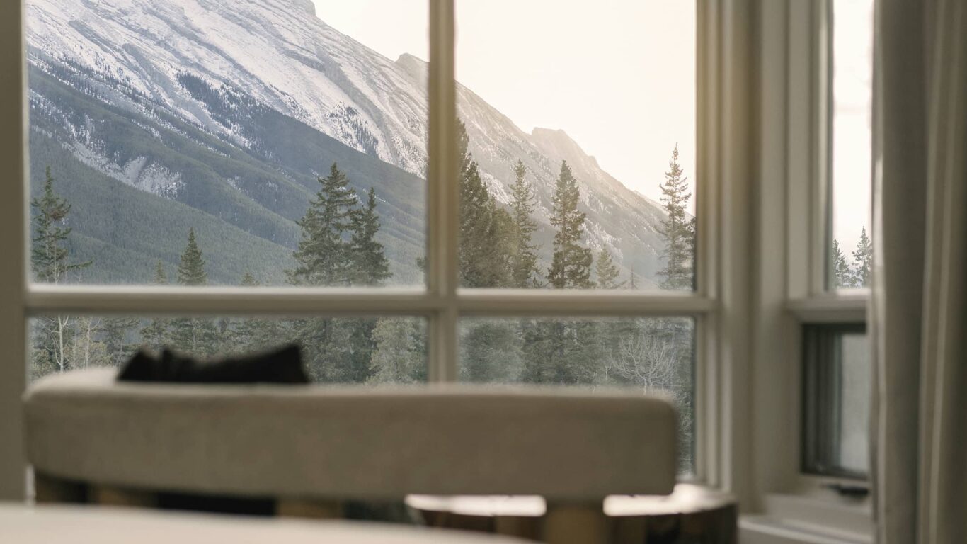Bedroom view at Rimrock Banff, Emblems Collection showcasing Mount Rundle and the beauty of Banff National Park.