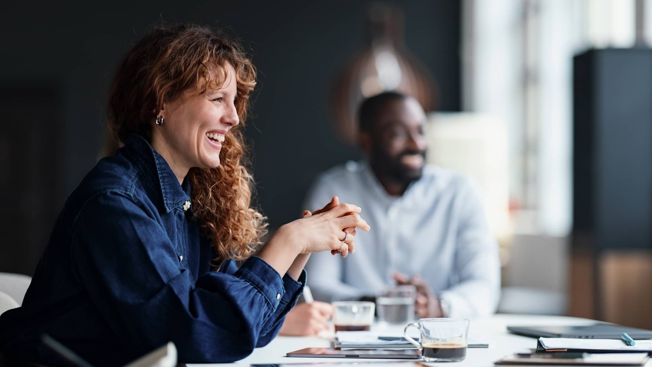 Team discussion taking place in the Dawn meeting room with natural light and views.
