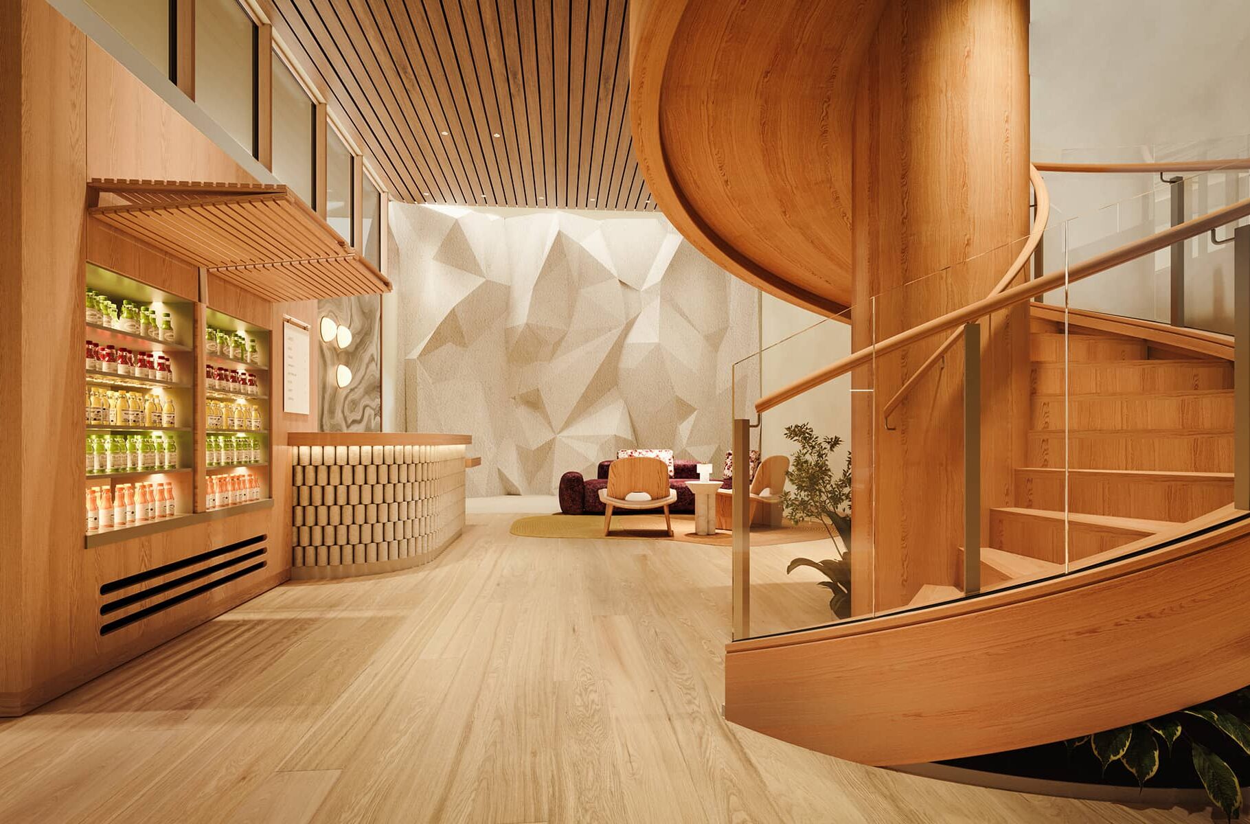The wellness reception at Rimrock Banff, Emblems Collection features a curved wooden staircase, a juice bar with bottled drinks, seating area, and sculpted climbing wall.