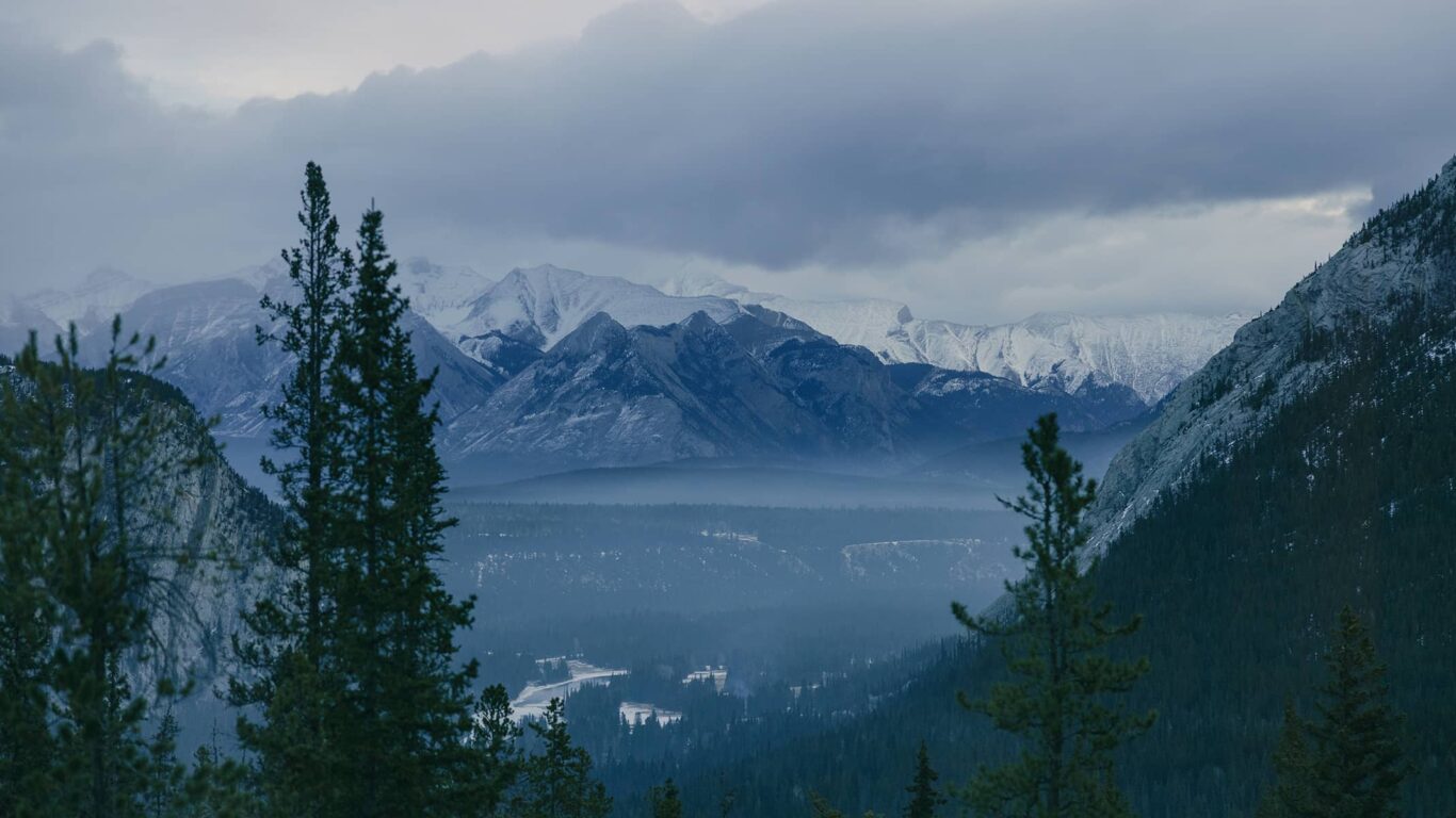 Video of Rimrock Banff guest rooms glowing with soft golden light, capturing cozy comfort, refined style, and the warmth of mountain luxury.
