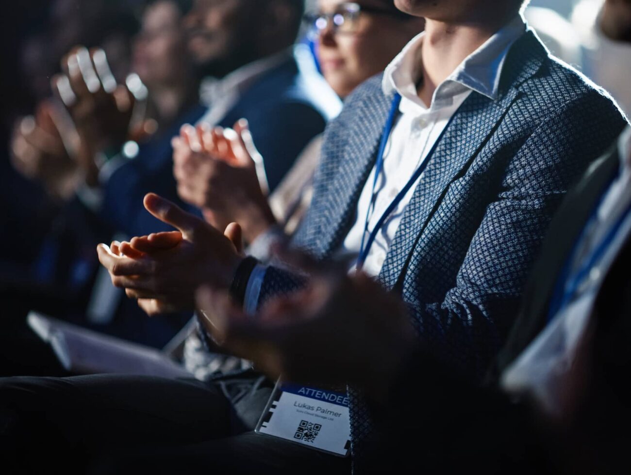 Attendees applauding during a presentation in the Waypoint meeting room at Rimrock Banff.