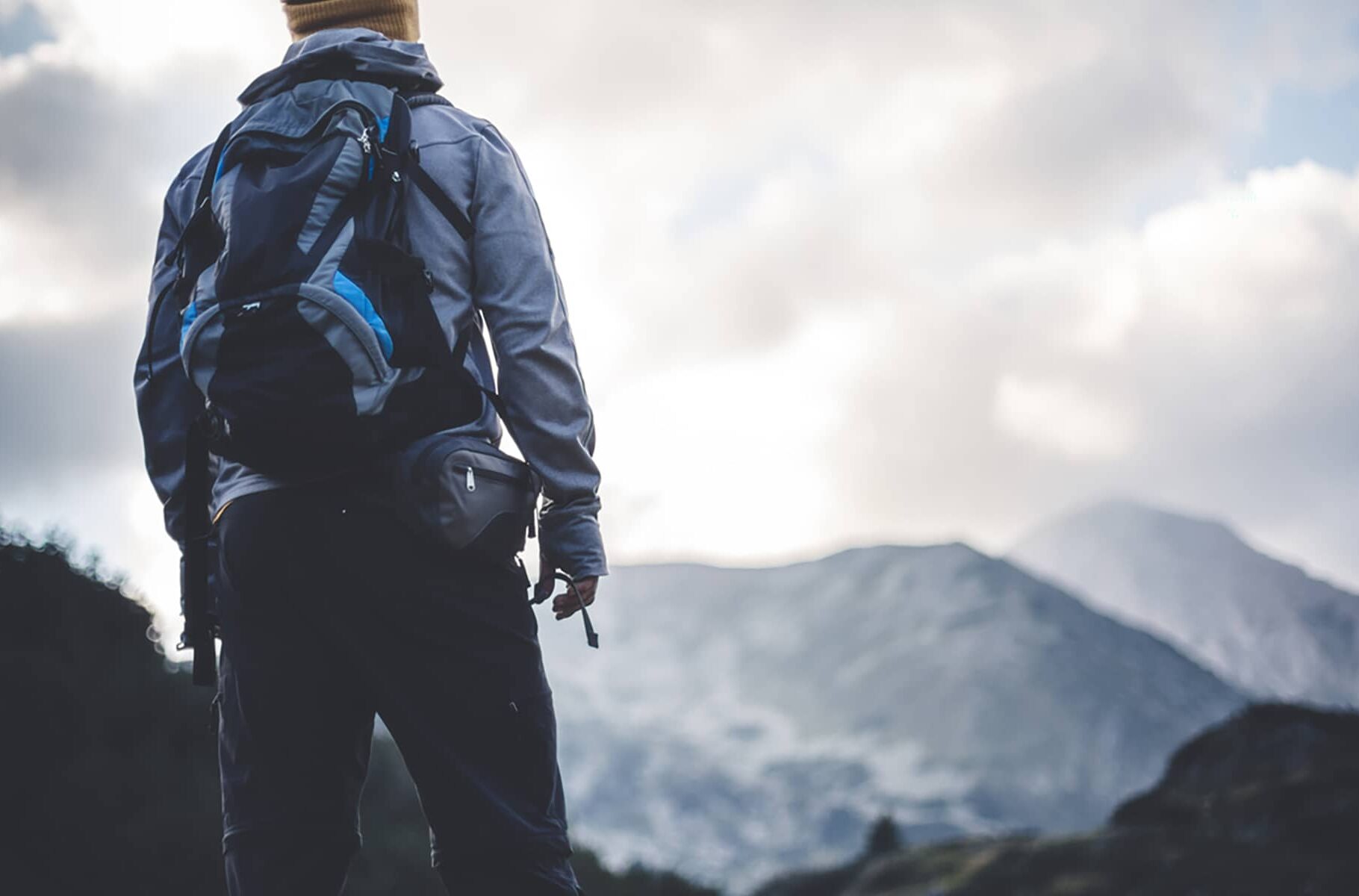 Hiker walking on mountain path,