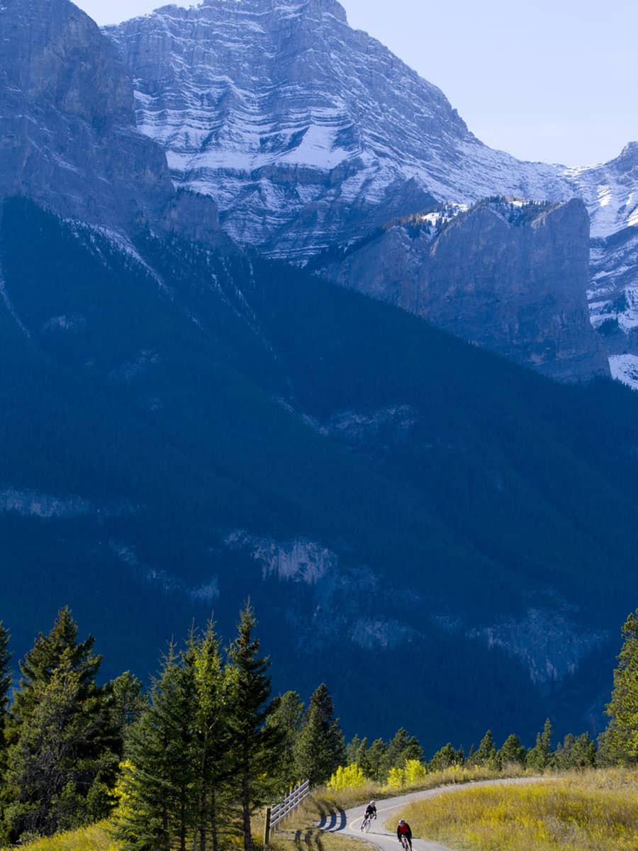 A father and son road bicycling on the Legacy Trail in Banff National Park, Alberta, Canada.