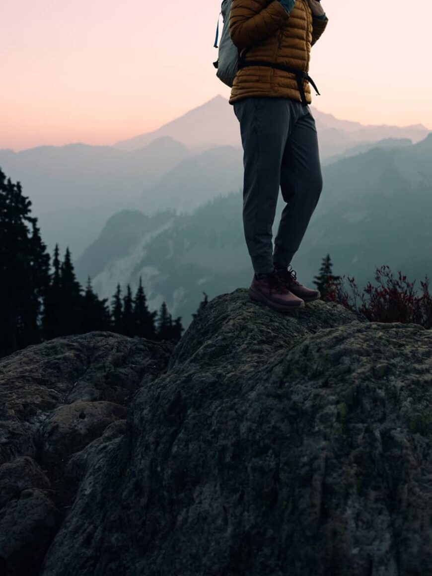 Luxury travel means a woman enjoys a hike on a beautiful Autumn day on Sulphur Mountian in Banff National Park.