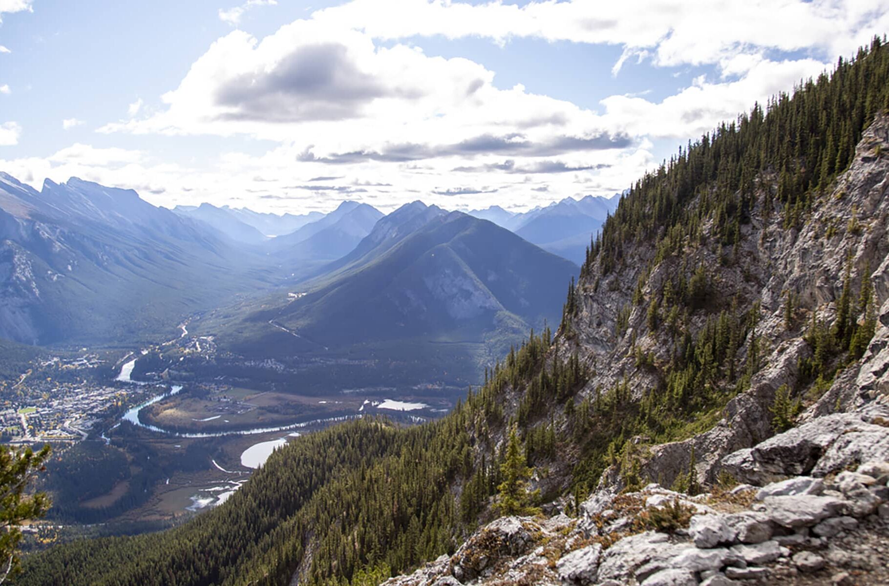 Panoramic view from Mount Norquay’s Via Ferrata, overlooking the Bow Valley and surrounding peaks under open sky.