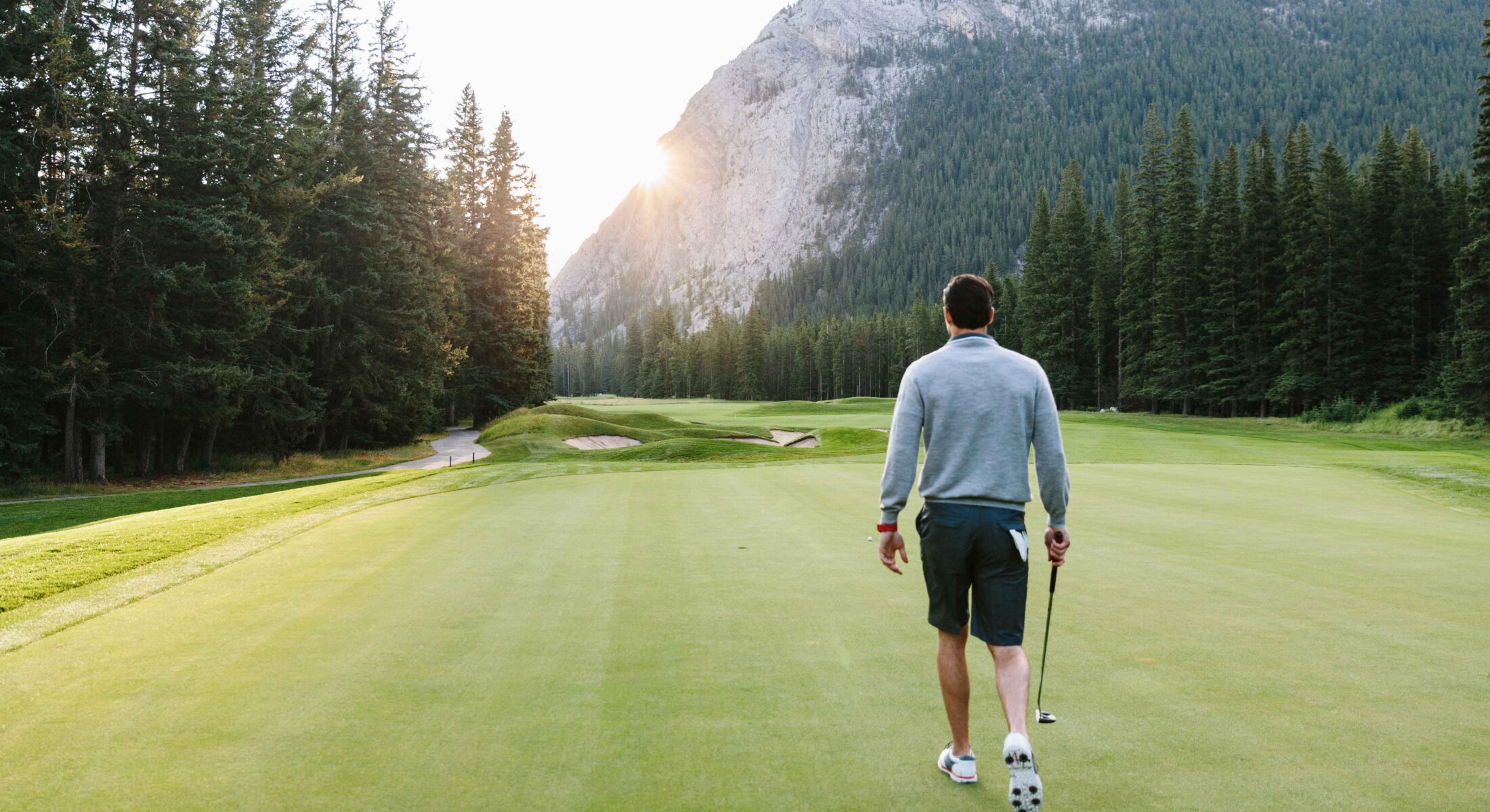 A man walking down the fairway at the Banff Springs Golf Course.