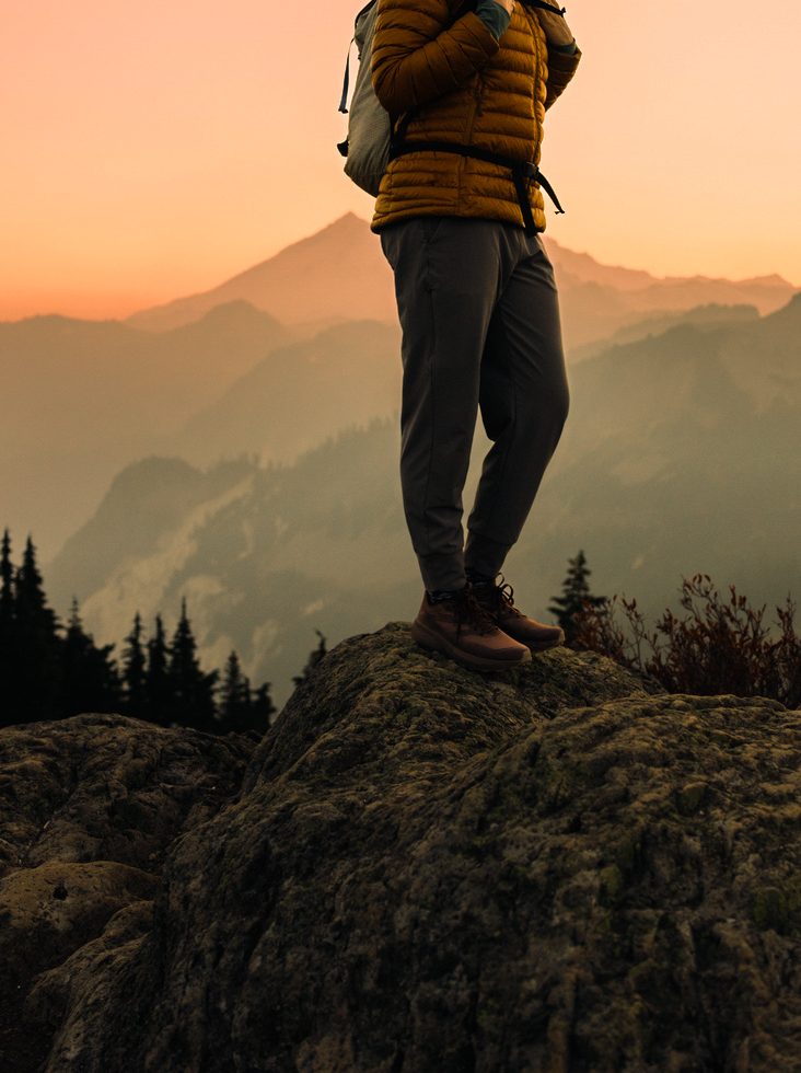 Luxury travel means a woman enjoys a hike on a beautiful Autumn day on Sulphur Mountian in Banff National Park.