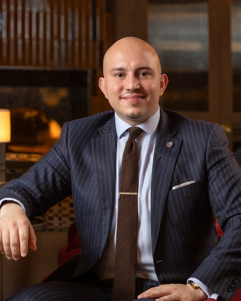 A professional photograph of the Director of Sales and Marketing at Rimrock Banff.