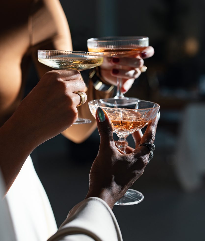 Three people enjoying Apres ski drink while staying at Rimrock Banff